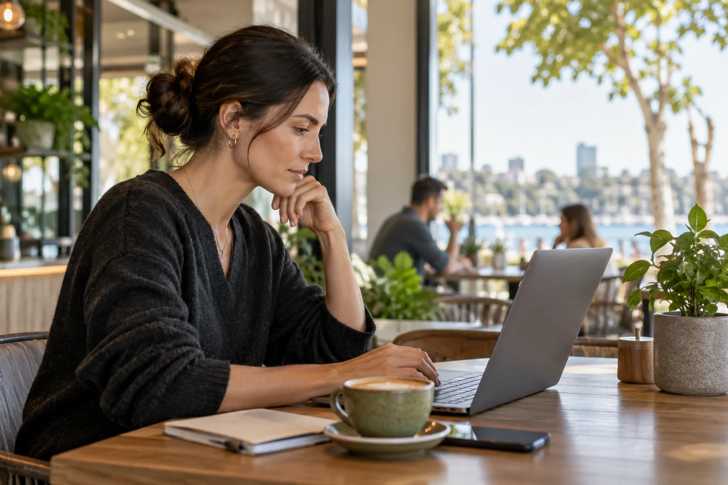 An adult reading service terms on a laptop in a cafe